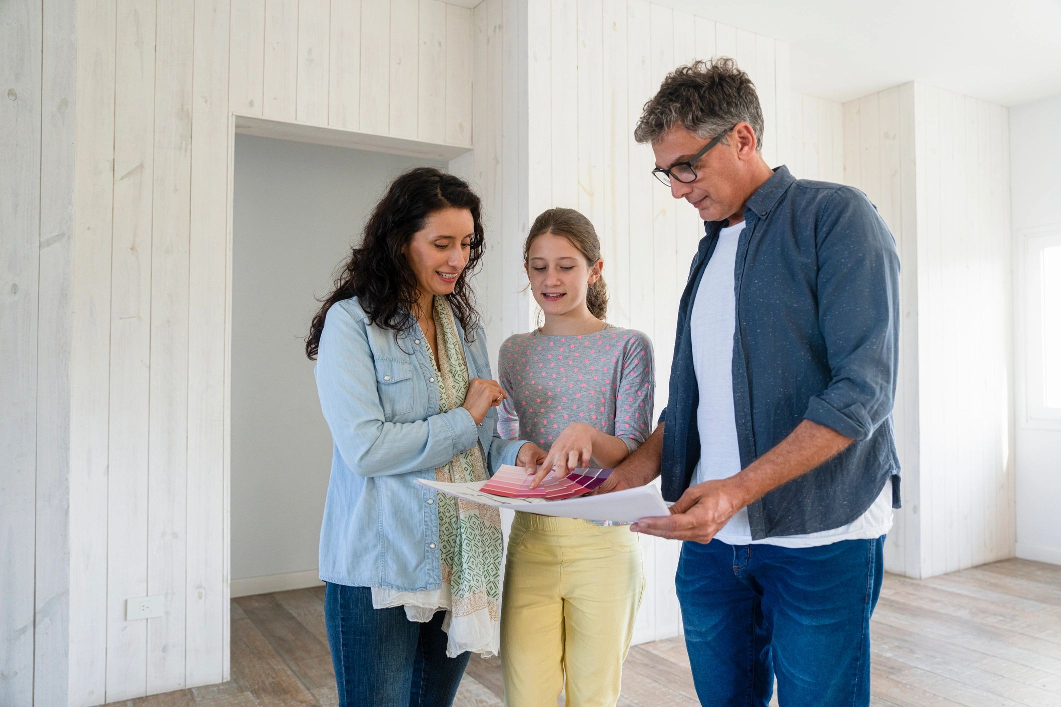 Family reviewing renovation plans with contractor