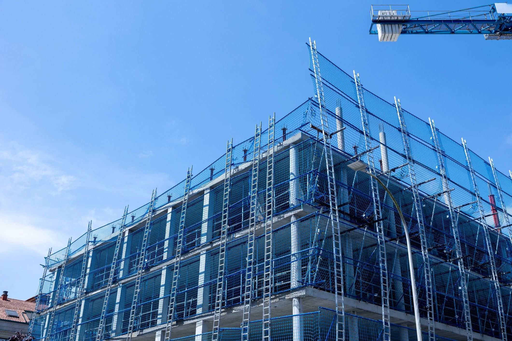 Building construction site with scaffolding and safety netting